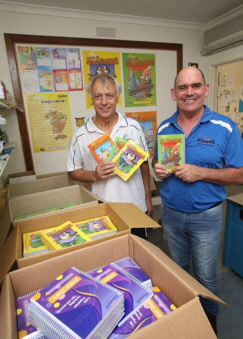 Stan Kluzek and Andrew Coldwell with their home reading program. Picture: PETER WEAVING