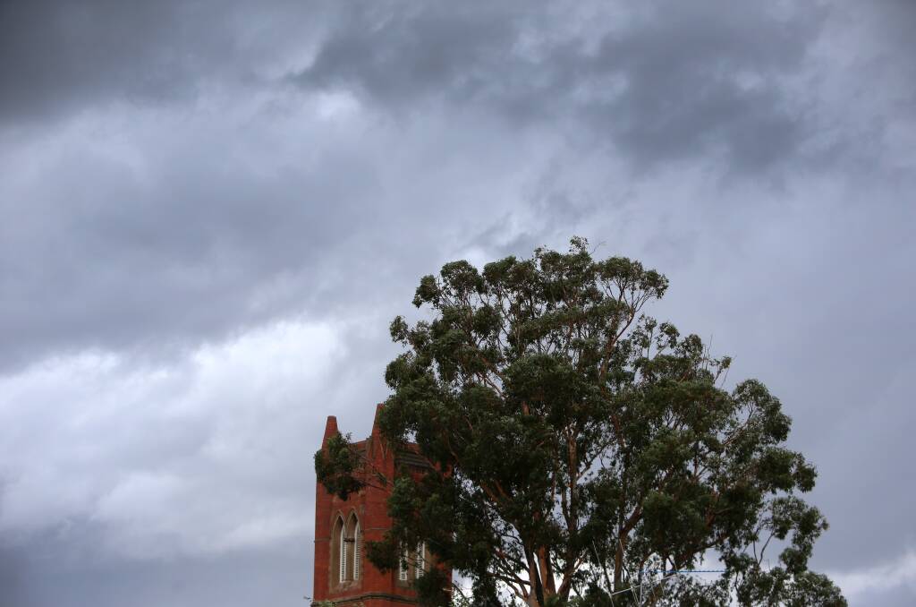 Dark clouds and rain falls in Bendigo. Photo: GLENN DANIELS