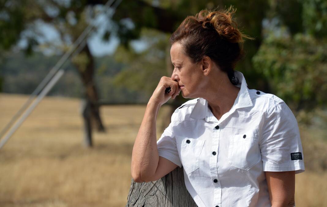 EMOTIONAL: Jane Riddell returns to her property which survived the fire. Picture: BRENDAN McCARTHY