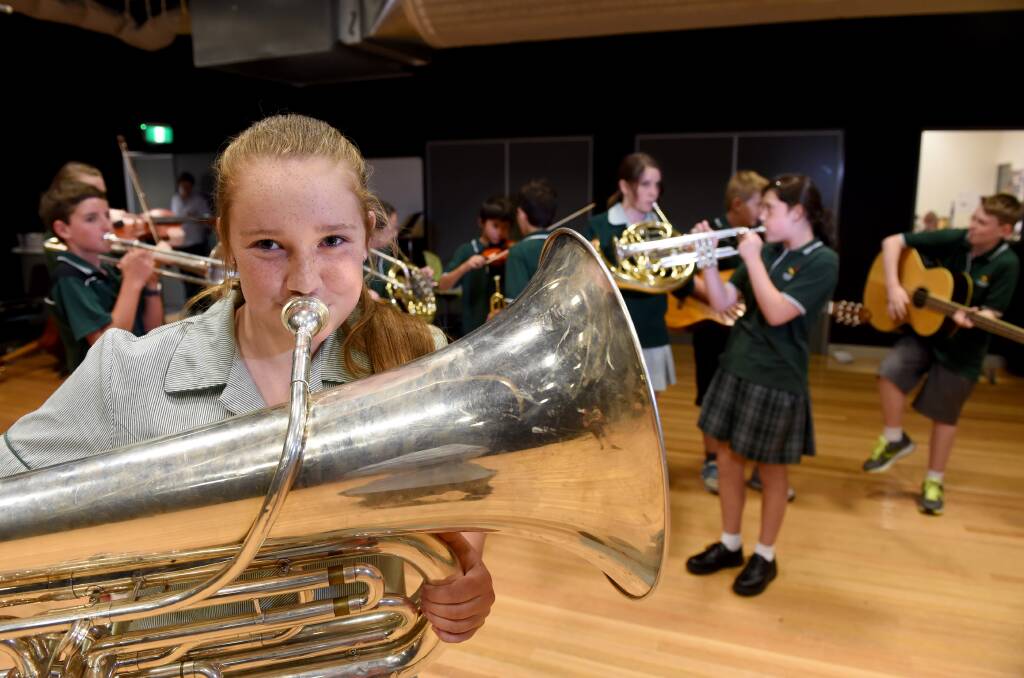 MUSIC TO THE EARS: Crusoe College year seven student Chloe Peters tests out the tuba on Tuesday. Picture: JODIE DONNELLAN 
