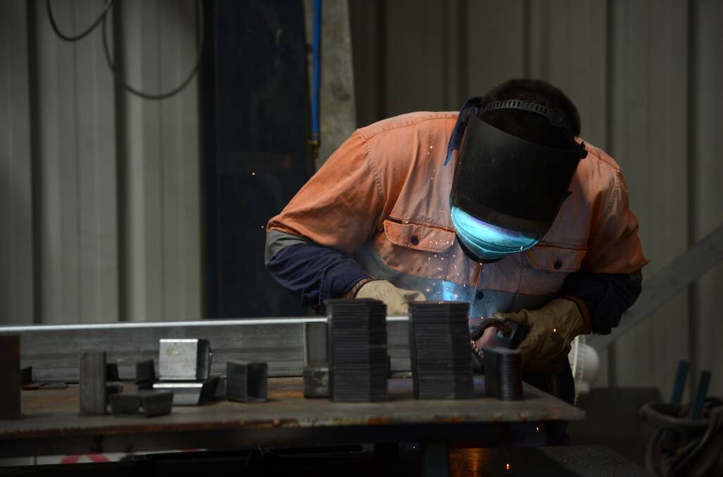 Welder Luke Percival from the Australian Turntable Company in the factory where the temperature can rise well above the outside air temperature. Picture: JIM ALDERSEY
