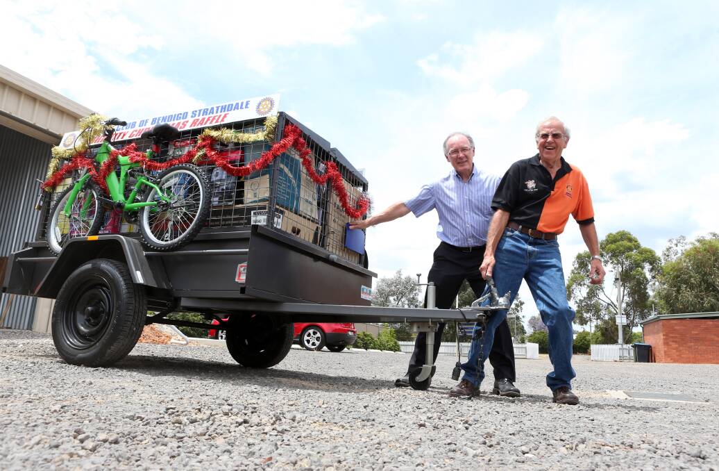 John Stewart and John Lindsay roll out the trailer for the Rotary Club Charity Christmas Raffle winner. Picture: PETER WEAVING