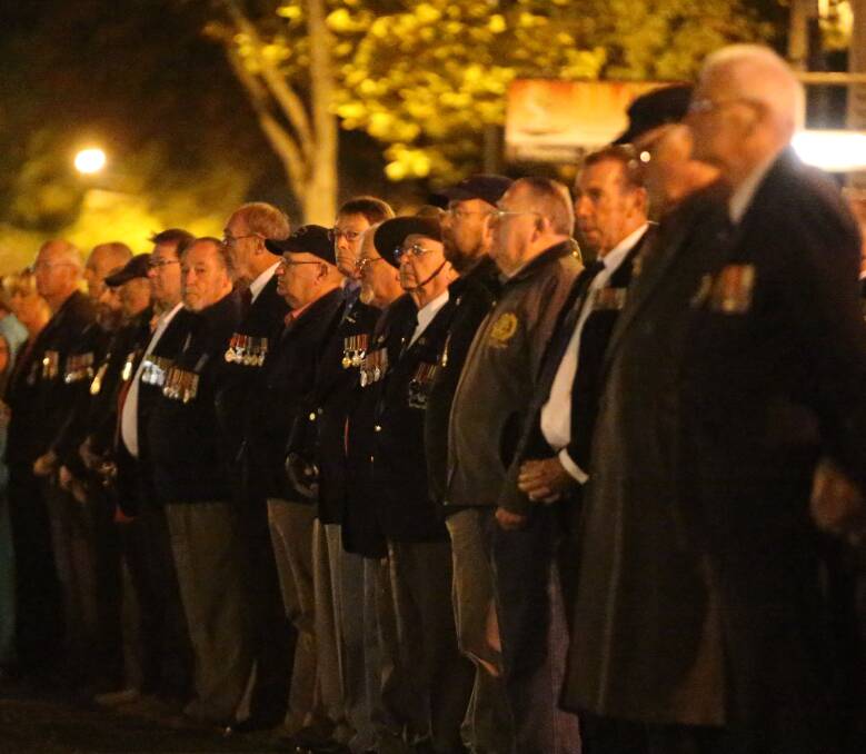 TRADITION: The crowd at the dawn service stands. 