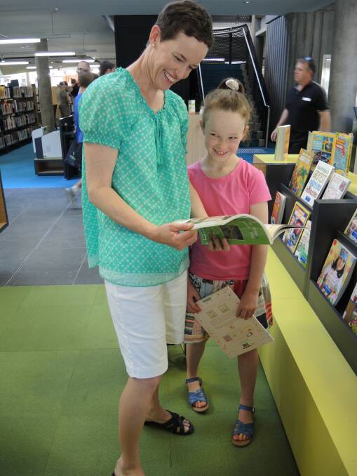 Elizabeth and Poppy, 8, Read test out the new library on Tuesday. 