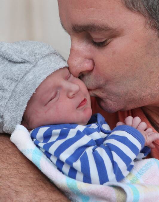 HELLO WORLD: Peter Anderson kisses his son Jack. Picture: PETER WEAVING 