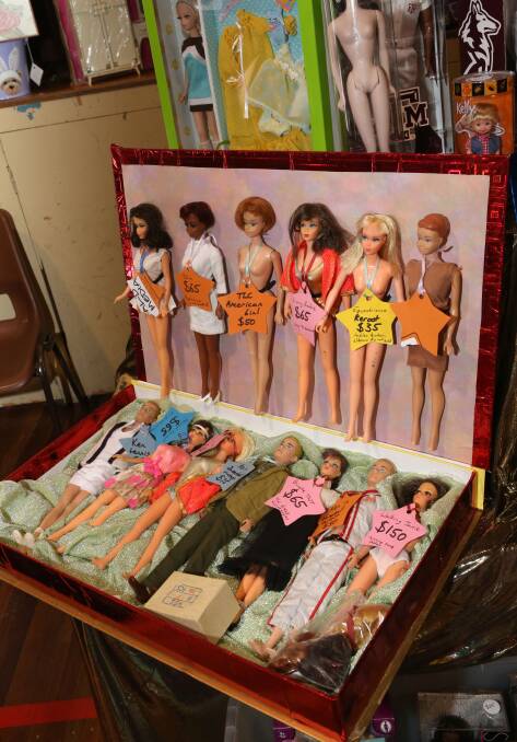 PRETTY: A box of dolls.
