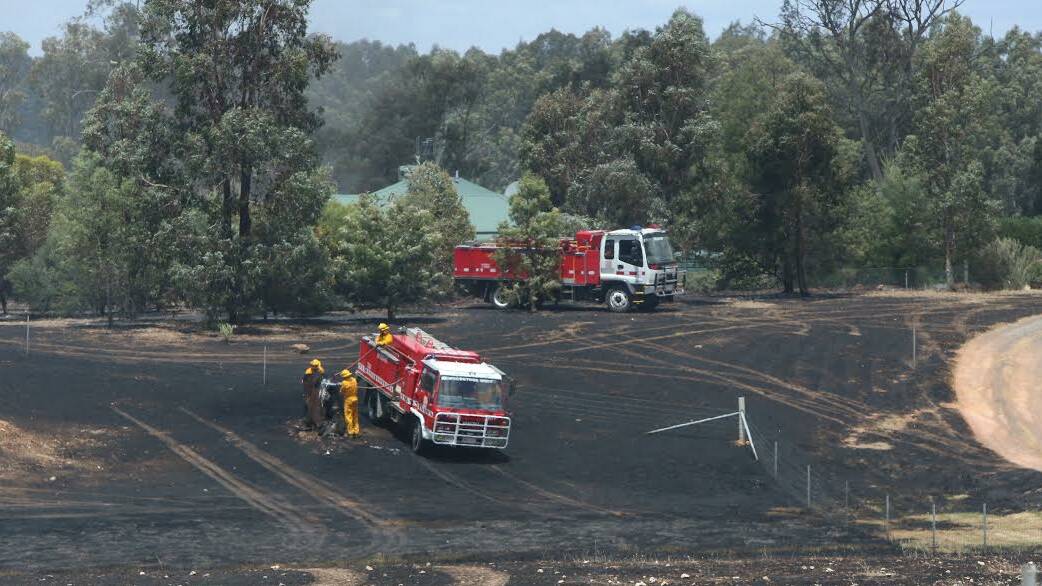 CLOSE: Green lawns helped CFA crews save this house at Laanecoorie from a grass fire. Picture: PETER WEAVING