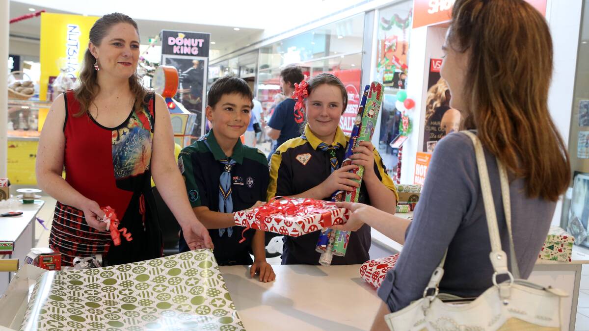 Adele Larcombe, Ashley Sharkey, Grace McSwain wrapping gifts for shoppers at the  Marketplace. Picture: LIZ FLEMING