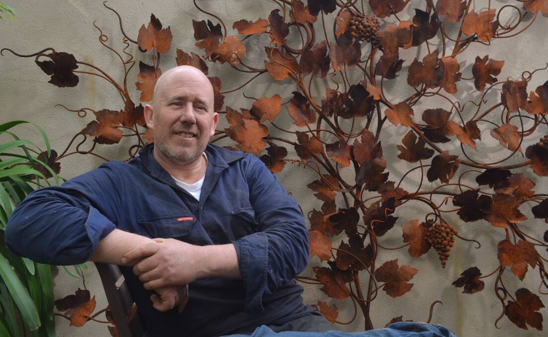 VINE MAGIC: Peter Gray in front of a grapevine wall feature. Pictures: BRENDAN McCARTHY