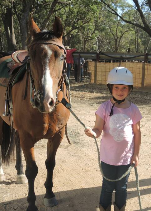 Charlotte Taylor from Macedon leads a horse her dad competed with.
 