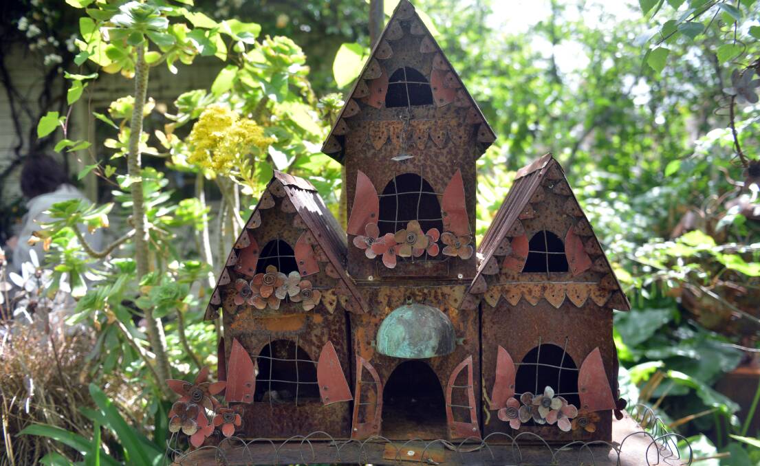 WHIMSICAL: a bird house made of rusted biscuit tins.
