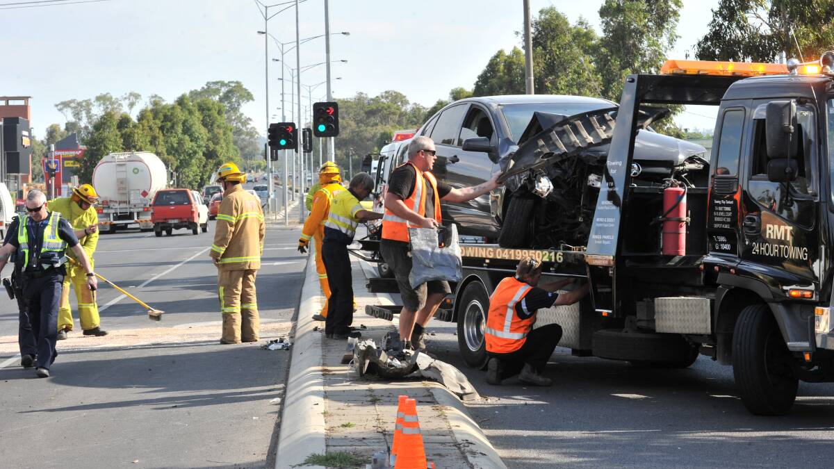 CLEAN-UP: Workers clean up after crash. Picture: JODIE DONNELLAN