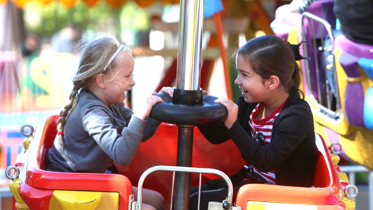 Tahlia Cunningham, 5 and Sarah Hill, 8 have fun on the teacup ride. Picture: GLENN DANIELS