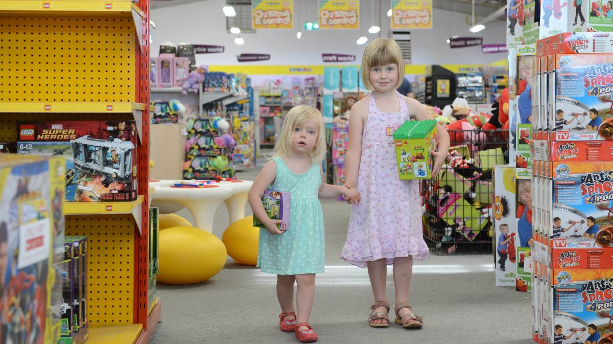 TIME TO SPLURGE: Susannah, 2, and Adelaide Seitz, 5, do some last-minute Christmas shopping at Toyworld. Picture: JIM ALDERSEY