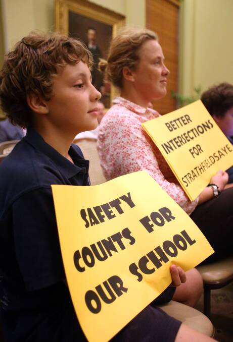 STOIC: Children hold placards at the City of Greater Bendigo council meeting. Picture: GLENN DANIELS