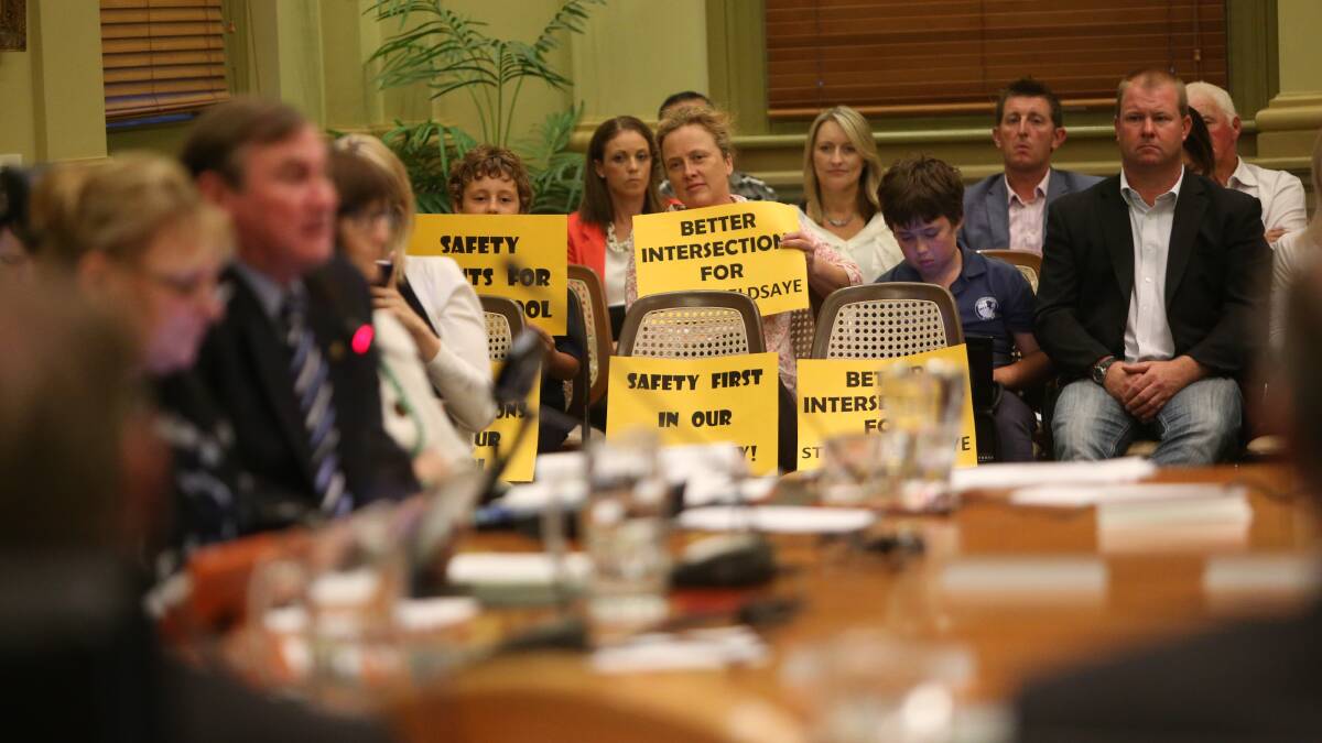 STOIC: Children hold placards at the City of Greater Bendigo council meeting. Picture: GLENN DANIELS
