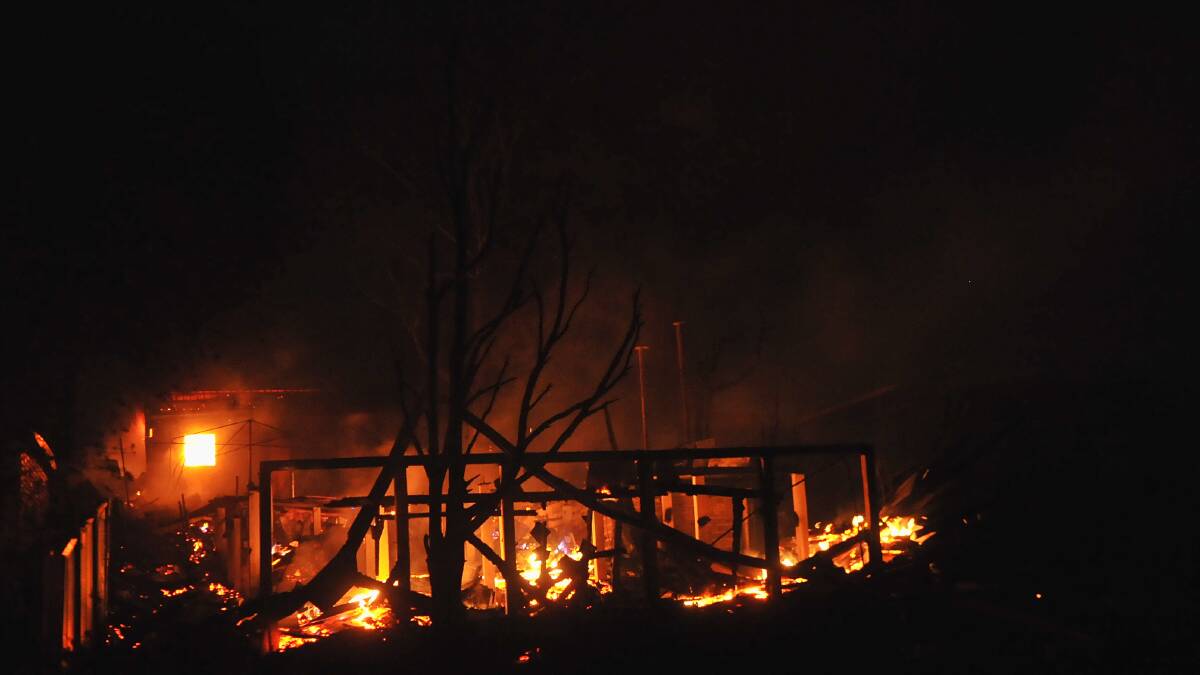 FEBRUARY 7, 2009: A house in Upper California Gully Road is engulfed by flames in the darkness. Picture: Julie Hough 