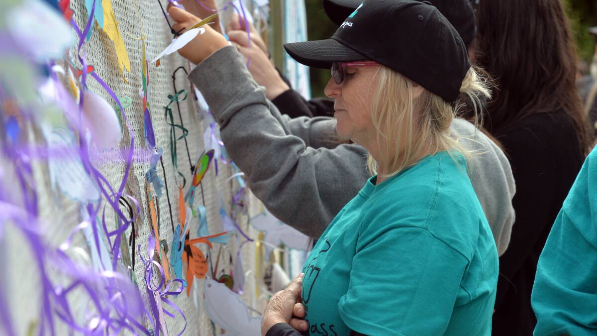 Kathleen Jacobson attaches a butterfly in memory of her son Wayne Brodhurst.