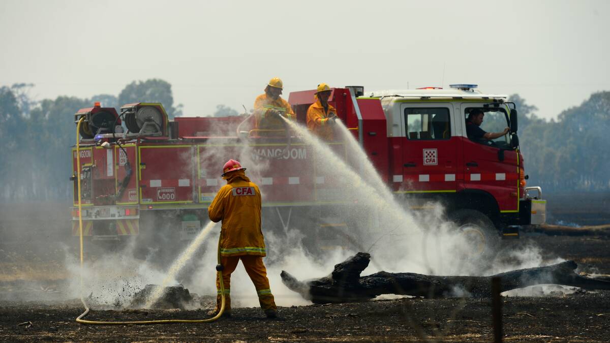 WORK: A fire crew works to extinguish spot fires at St Helens Plains near Horsham. Picture: THE AGE