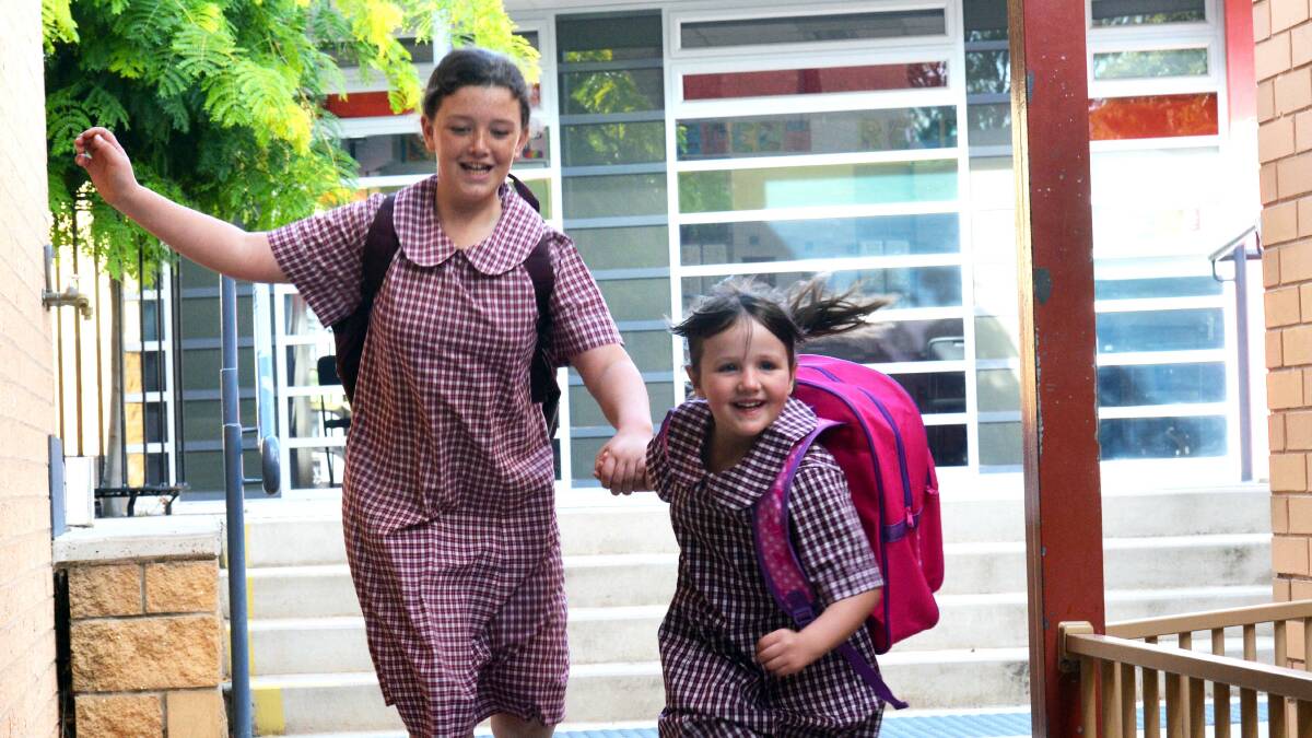 Big sister Alexis and Phoebe Dunsmuir on Phoebe's first day at school at St Therese's Primary School. Picture: BRENDAN McCARTHY