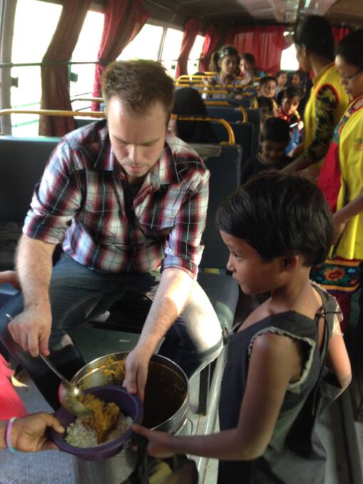 SERVE OF LOVE: Jeremy Dyck serves an Indian girl a healthy meal to take back to her family in the slums. 