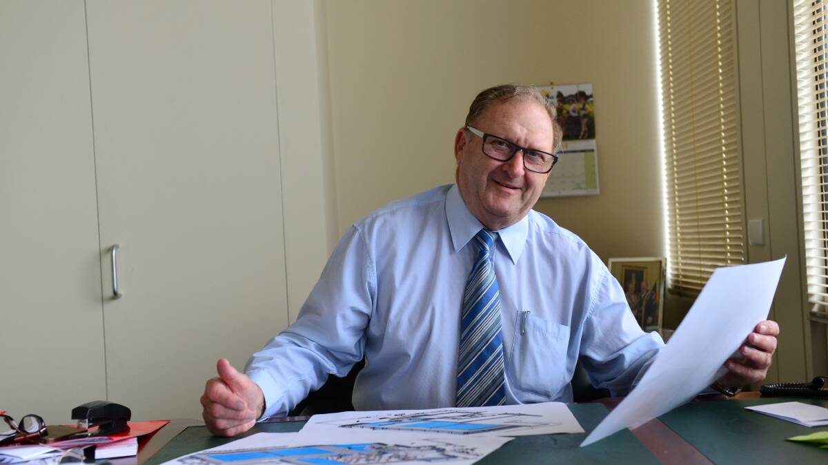 PUSH: Mayor Barry Lyons looks over aquatic centre plans. Picture: JIM ALDERSEY