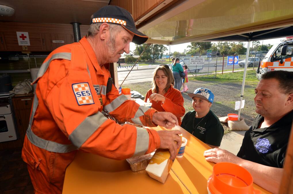 HELPING: Greg Cheyne of Marong SES serves coffee to travellers at the Driver Reviver Centre in Marong.