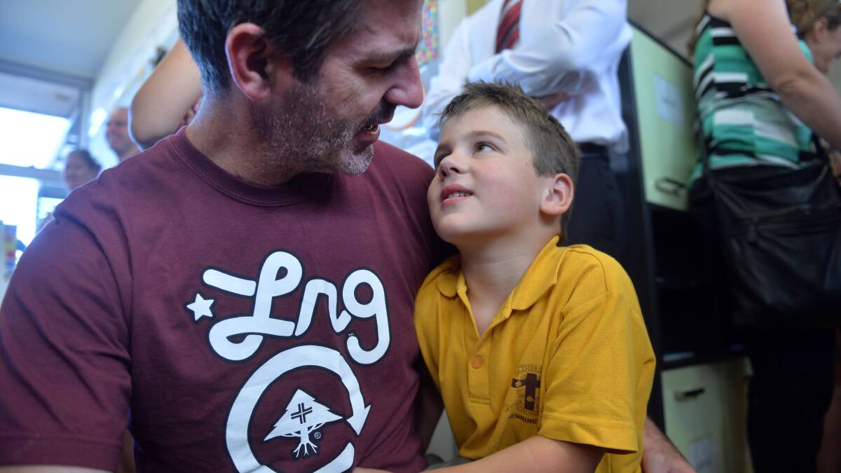 Dad Jamie Gee and Ben share a moment amid the chaos of Preps' first day at St Therese's Primary School. Picture: BRENDAN McCARTHY
