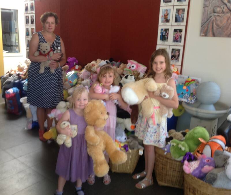 DONATED: Jodie Keast with Maddie (far right) and her friends with the donated teddies. Pictures: CONTRIBUTED