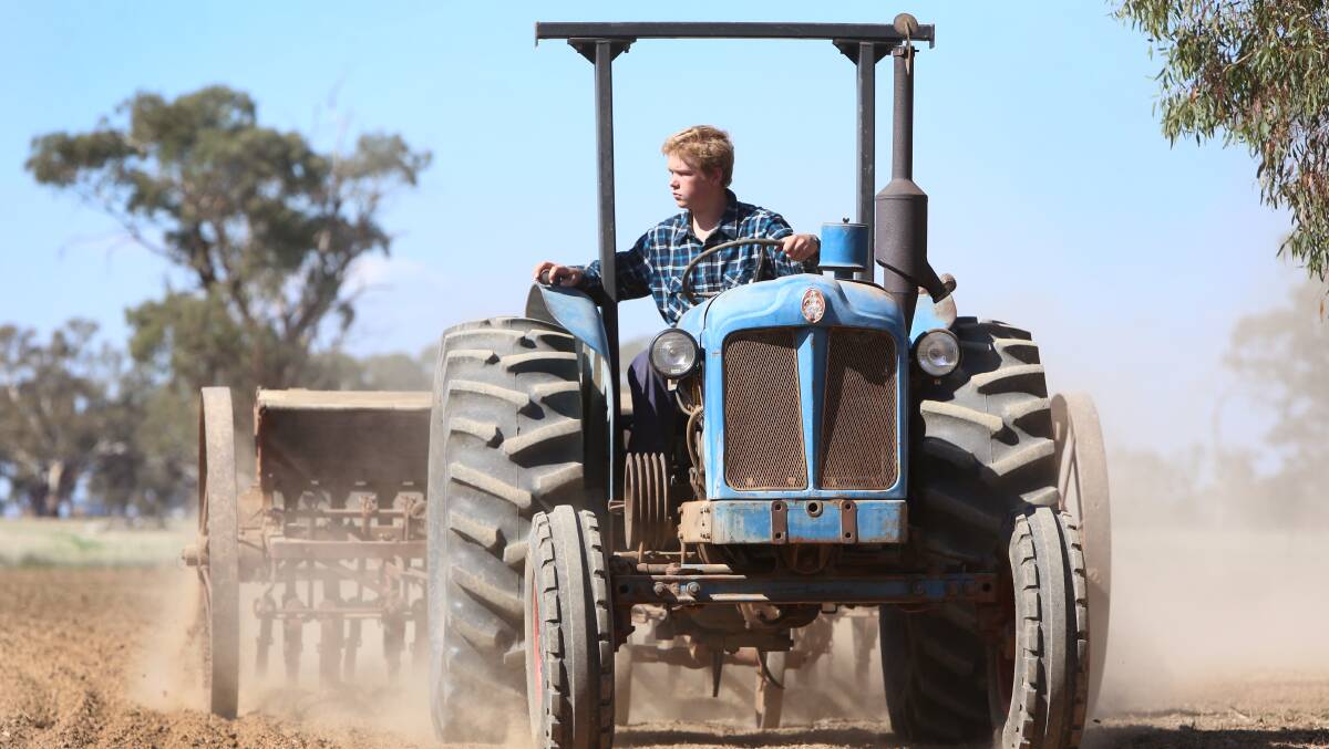 WORKING IT: Nick Collins, 14, has fixed up his grandfather's 1920s H.V McKay seeder. Picture: GLENN DANIELS