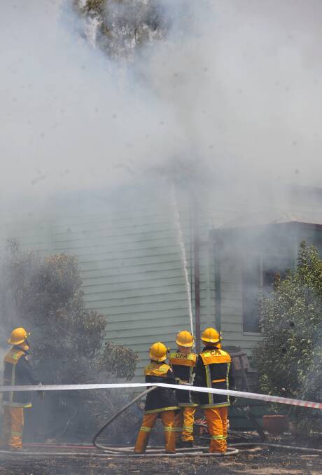 FEBRUARY 7, 2009: Firefighters work to douse a Quarry Hill house fire. Picture: Julie Hough