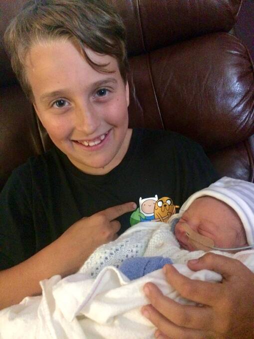 BROTHERS: Angus, 11, holds baby Finn. 