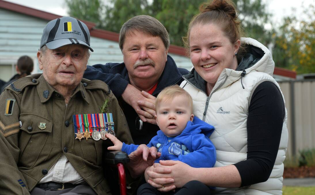 WWII veteran Cec Shilling with son Glen, grand daughter Allese and 8-month-old great-grandson Oliver at today's Anzac Day service at Kangaroo Flat.  Picture: BRENDAN McCARTHY