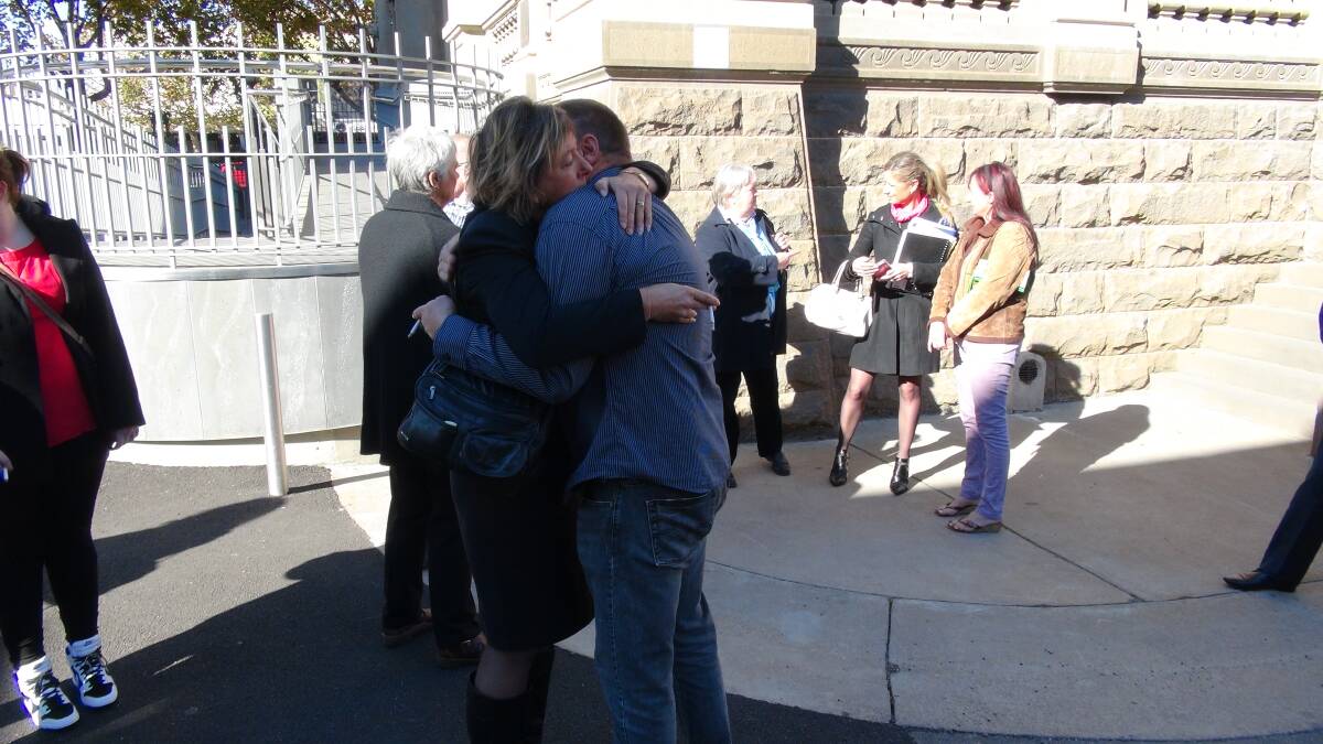 GRIEF: Family members of William Stevenson embrace after Danielle Kerr's murder sentence yesterday.