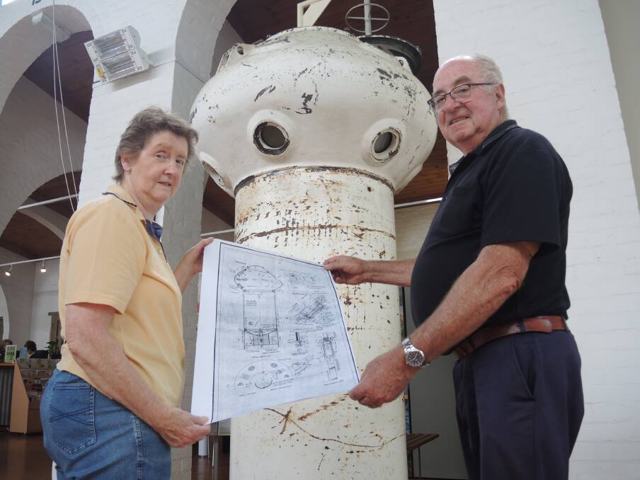 Castlemaine Historical Society's Carol Dorman and Maldon Vintage Machinery Museum's John Conn with a diagram of the diving bell.