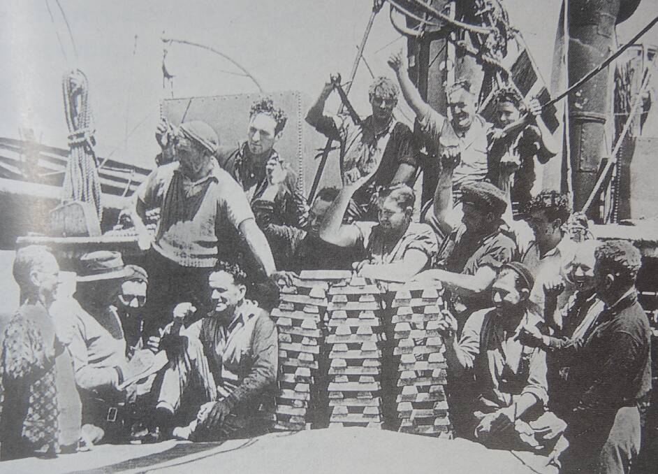 The crew of the Claymore with some of the gold bullions recovered from the sunken RMS Niagra.