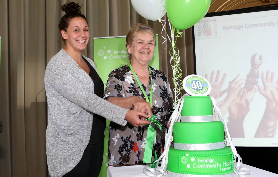 CAKE: Bendigo Community Health Services longest serving employee Paula May and its most recent employee Mellisse Oakes cut the cake. Picture: PETER WEAVING