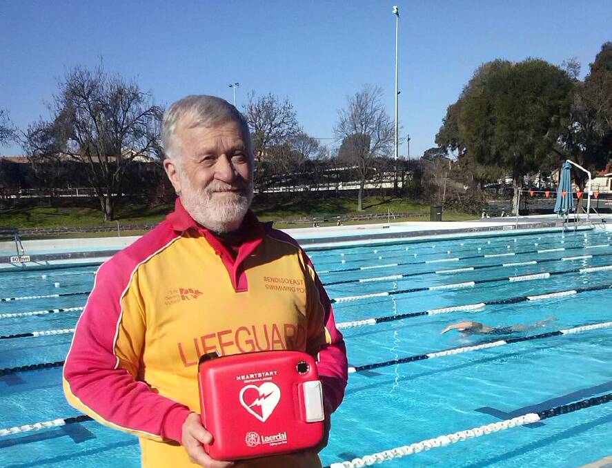 Life saver: Bendigo East Swimming Pool staff member Rob Bath with the defibrillator. Picture: contributed.