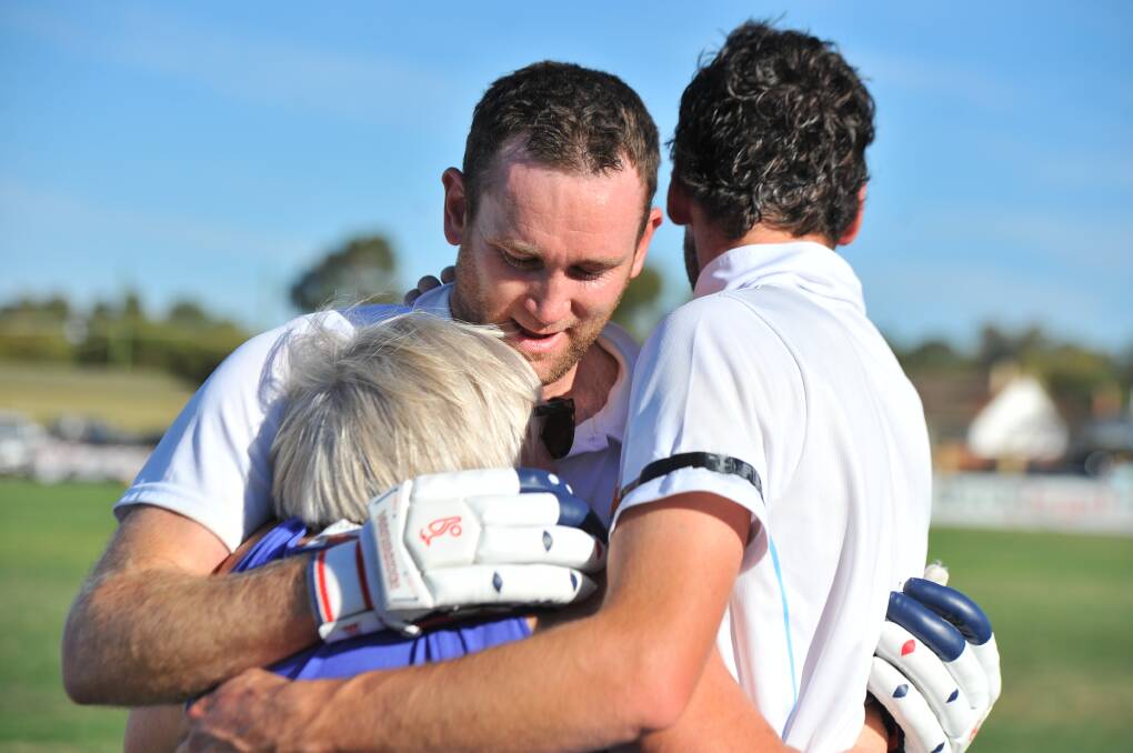 EMOTIONAL: Ben DeAraugo and Jacob DeAraugo (back turned) after Sunday’s win. Picture: LIZ FLEMING