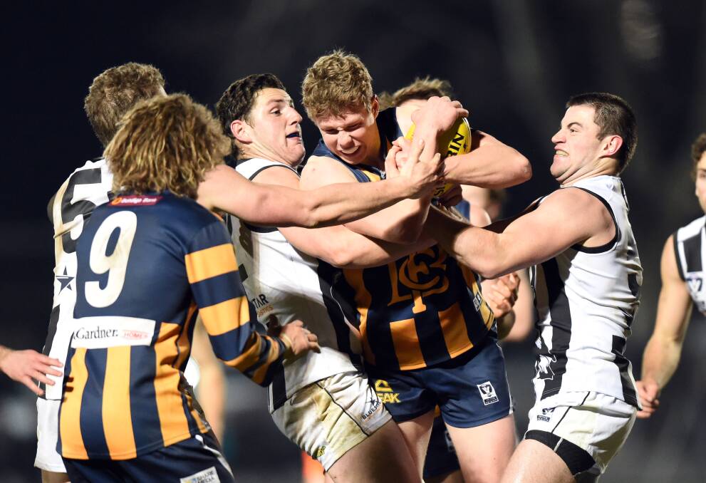 CONTEST: Bendigo’s Joe Redfern tries to crash through a pack during Friday night’s VFL finale against Collingwood at the QEO. Picture: GLENN DANIELS