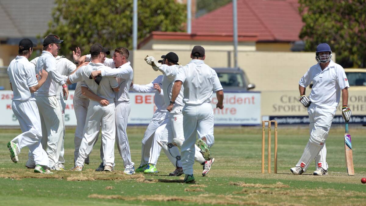 The Demons celebrate their match-winning wicket.