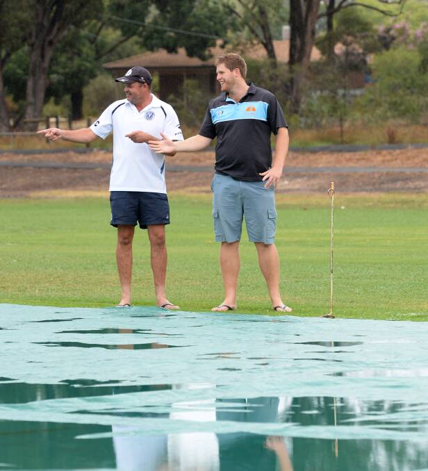 Huntly's Michael Hanson and Strathdale's Matt Thomas at a wet Bell Oval on Saturday.