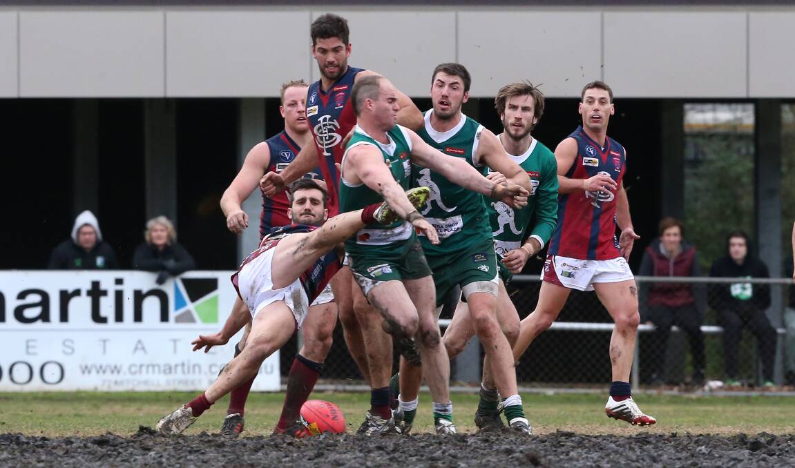 CONTEST: Sandhurst's Ryan Maldenis is pressured by Kangaroo Flat's Billy White in the centre square on Saturday. There were 44 goals kicked in the shoot-out. Picture: PETER WEAVING