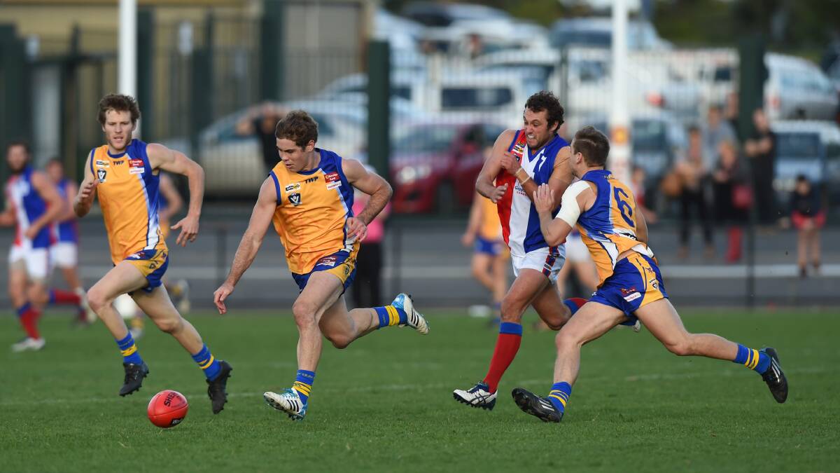 OFF AND RUNNING: Bendigo's Brodie Filo bounces while team-mate Mitch Dole shepherds.