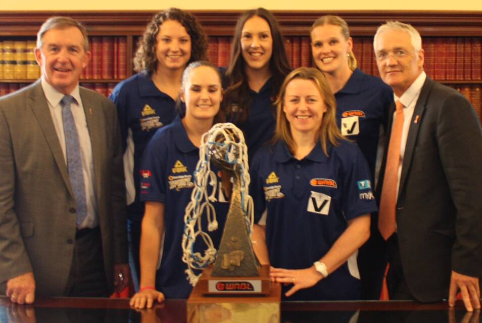 TOP END OF TOWN: Hugh Delahunty, Kelsey Griffin, Kelly Wilson, Gabe Richards, Kristi Harrower, Chelsea Aubry and Damian Drum with the WNBL trophy at Parliament House. Picture: CONTRIBUTED
