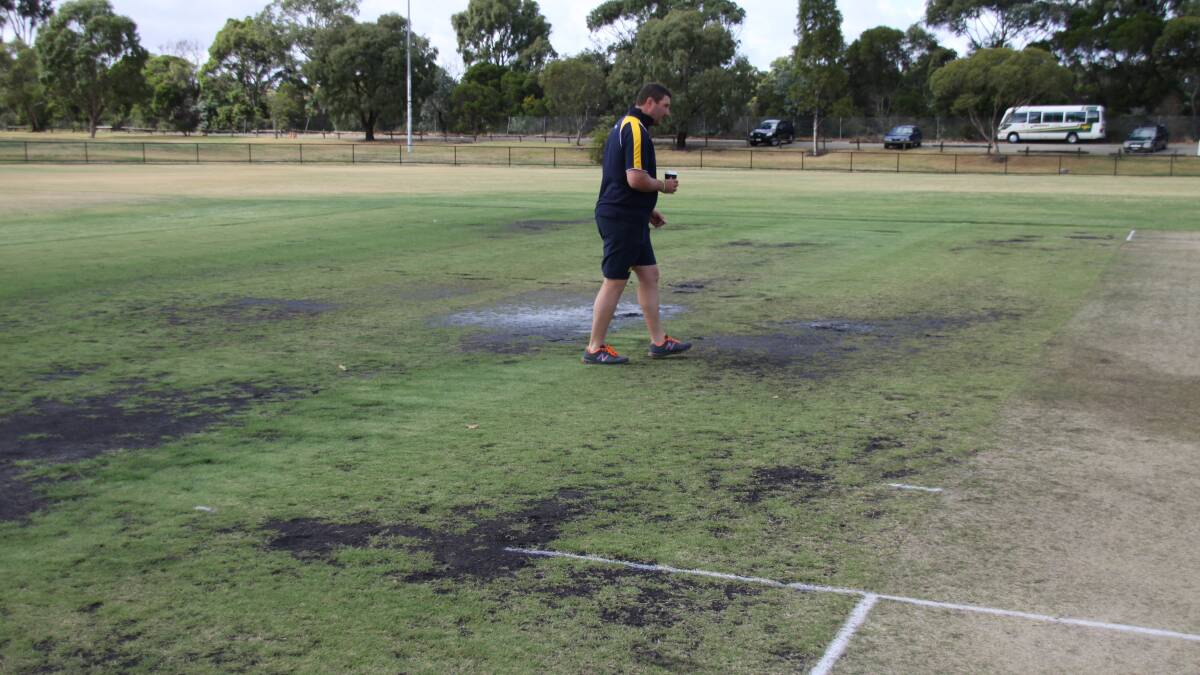 Bendigo's Adrian Pappin inspects the wet Endeavour Hills ground.