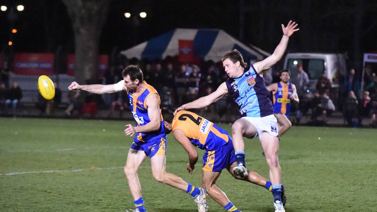 DISCIPLINED: Golden Square defender Matt Tyrrell punches the ball in Saturday night's elimination final win over Eaglehawk at the QEO. Picture: LIZ FLEMING