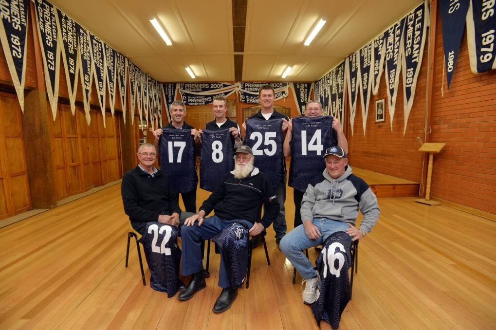PROUD HISTORY: Back: Dean White, David McNamara, Nick Harrop and Alan Kennedy. Front: John Tuohey, Barney Nihill and Denis Roney with the commemorative Mount Pleasant jumpers that will be worn this Saturday. The seven are in the club’s social rooms that is adorned with premiership flags. Picture: BRENDAN McCARTHY