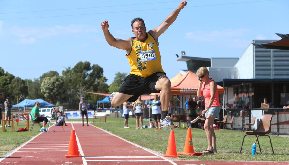 LEAP: Jamie Muscat contests the long jump leg of the 35-59 years track and field pentathlon. Picture: PETER WEAVING 