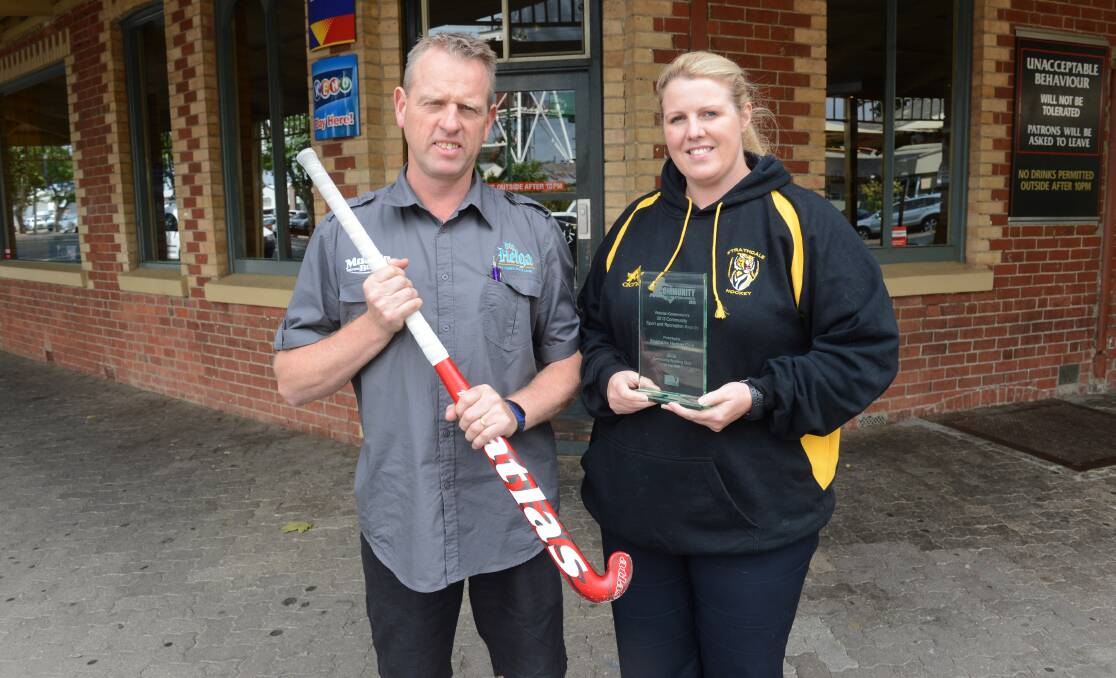 HONOUR: Bruce Morcom from the National Hotel and Strathdale Hockey Club president Nicole Hood with the Club of the Year Award. The National Hotel is Strathdale's major sponsor. Picture: PETER WEAVING